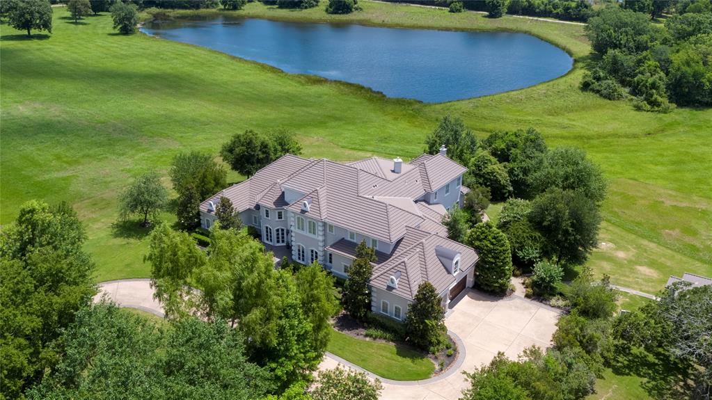 Stunning 7871 sf, 5/6 bedroom country estate on 50 acres with private 6 acre stocked lake surrounded by huge, scattered trees. Completely private but only 15 minutes to Lake Conroe. Automatic gated entrance, covered/lighted B-Ball/tennis court(could add siding and have a +- 8000 sf warehouse), whole house generator, 400 sf kennel, stables, tack room, outdoor kitchen, pool with slide, waterfalls, fountains and hot tub. Interior is totally exquisite. Gorgeous tile throughout first floor and hardwoods in all bedrooms and stairwell. Huge kitchen opened up to great living area and a wall of glass with pool and lake views. Great study down with unbelievable woodwork. Wolf Range, Subzero fridge and new audio/visual system. Large, secluded guest suite down with private bath. HUGE utility room with laundry chute. All upstairs bedrooms have private baths. Gameroom and media room up with pocket doors and balcony overlooking pool and lake. TV's and upgraded audiovisual all stay. Must see this one!
