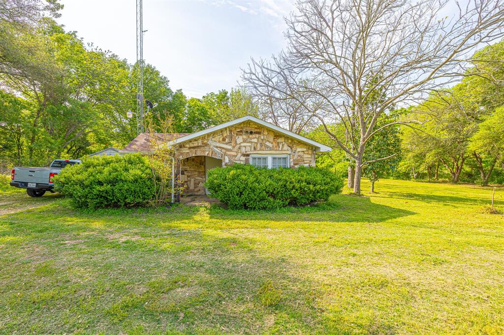 Enjoy this beautiful piece of Central Texas with close-to-town amenities. The possibilities are limitless with this UNRESTRICTED property! Located directly on HWY 21 on 4.083 acres, this property features a 1,056 sqft home. 20 miles from College Station and 8 miles from the City of Caldwell. The home has a unique stone/petrified wood exterior with good bones just needs some TLC.