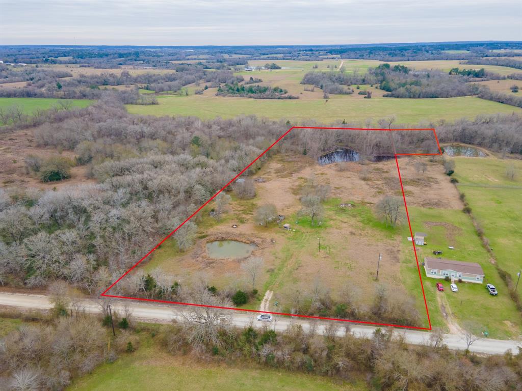 Enjoy the peaceful scenic drive up to this 8 acre unrestricted parcel in Plantersville. 2 ponds for your recreation and enjoyment, come & stock them with your favorite fish. Beautiful oak trees and vistas of your pond in back make a great backdrop for your future homesite. Underground electricity, cable, and phone are installed and ready for you. Property has been used for harvesting hay and is mostly cleared. This tract backs to a seasonal creek. Don't miss your opportunity to own this little piece of Texas! Boundary lines shown are approximate, seller does not have a survey.