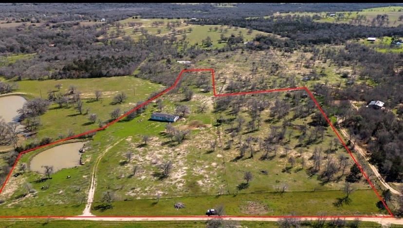 12.77 Acres in Cedar Creek. Fantastic location!! 10 minutes from Bastrop! 25 minutes from Austin! Mobile home has 4 bedrooms and 2 baths. Property has 2 pens (could be 3), High fence, Pond. Agriculture Exemption is in place. Property has cattle that seller could sell or possibly lease. Property has electric, city water and septic. Make an appointment to see today!