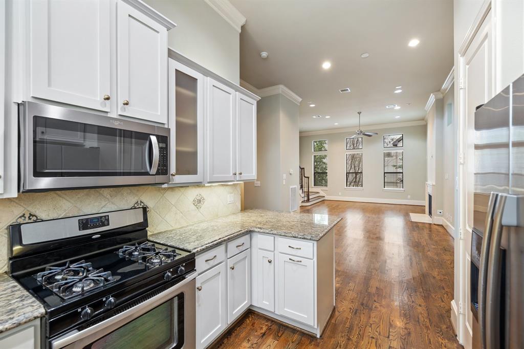 The kitchen also includes stainless steel appliances including built-in microwave and gas range. Per the seller, a new microwave was installed in 2021.