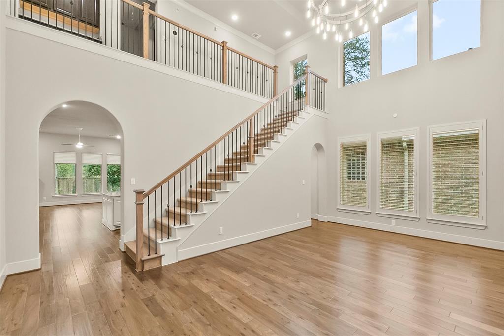 Large formal dining room and beautiful staircase lead to the upstairs suite and media room. Luxurious wood blinds.