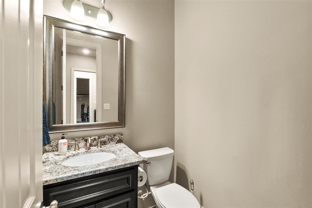 Powder bath near garage entrance, right off of the formal living room.