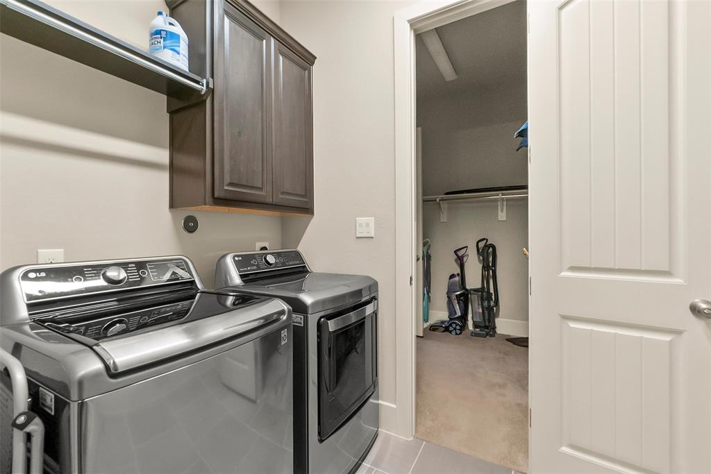 Utility room situated right off of one of the two walk-in primary closets.