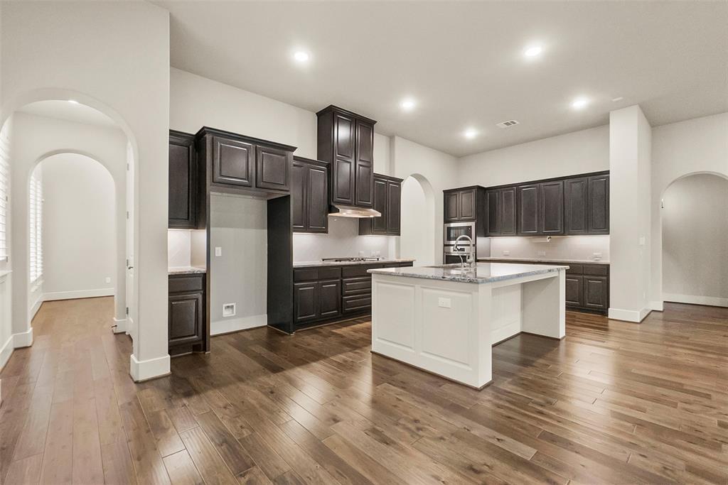 Walk-in pantry is tucked behind the fridge and cook top, right under the staircase.