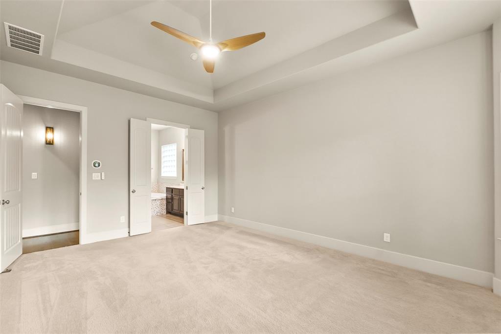 Tray ceiling features a ceiling fan and motion-sensing lights.