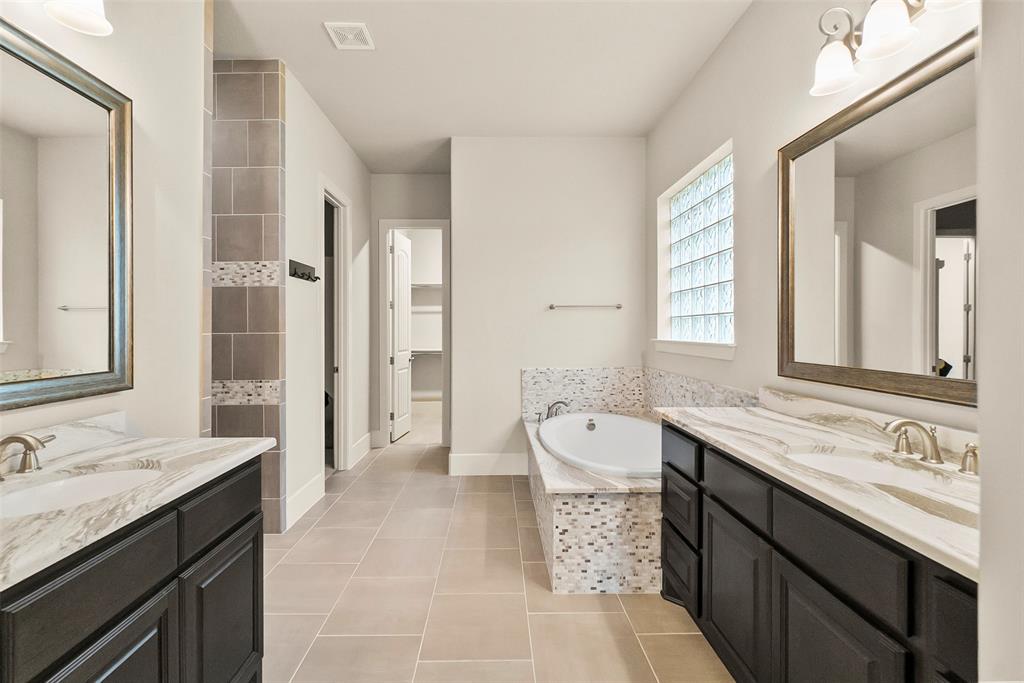 Dual vanities and a jetted tub.