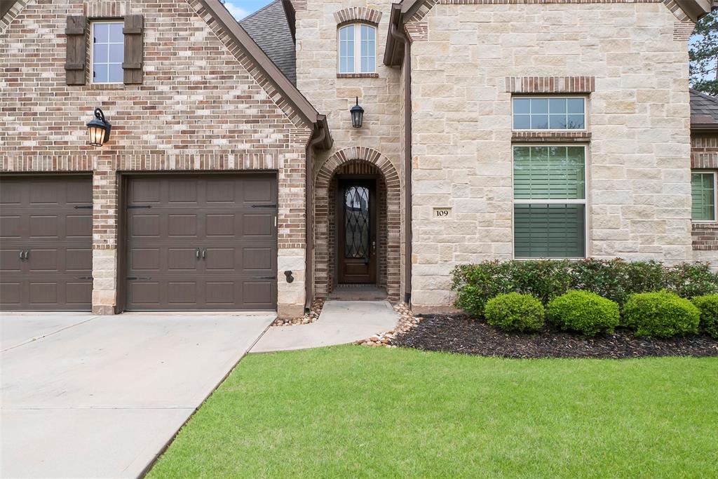 The front door and professional landscaping welcome you inside this exquisite home.