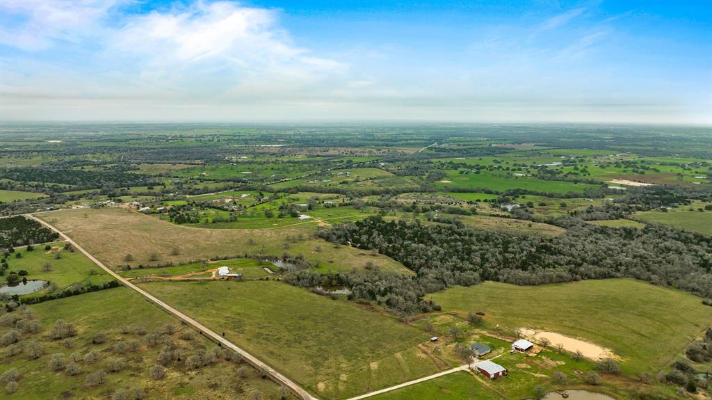 This 142+/Acre Ranch holds a unique opportunity for investors, cattle/horse operators, hunters, farmers, or rural land owners. The property is currently ag-exempt and has almost 2000’ of road frontage! The appealing 3BD/2BTH ranch home is a rare find. The home is found on a pleasant county road with multiple access options. Drive home down CR-103 or take advantage of the recorded easement access on PR-8025 (many great access options for potential developments if desired). Relaxing views of the woodlands and piqueteros ponds are among the reasons to be glad for the pleasant commute home. This property is conveniently located in the heart of Central Texas within 7 miles to Giddings, 15 miles to Bastrop, 25 miles to Round Top, 45 miles to Austin, and 95 miles to Houston. The property site also includes a large barn with horse stalls, an enclosed kennel barn, a storage shed, and several loafing sheds. It's going to feel great to call this place home!