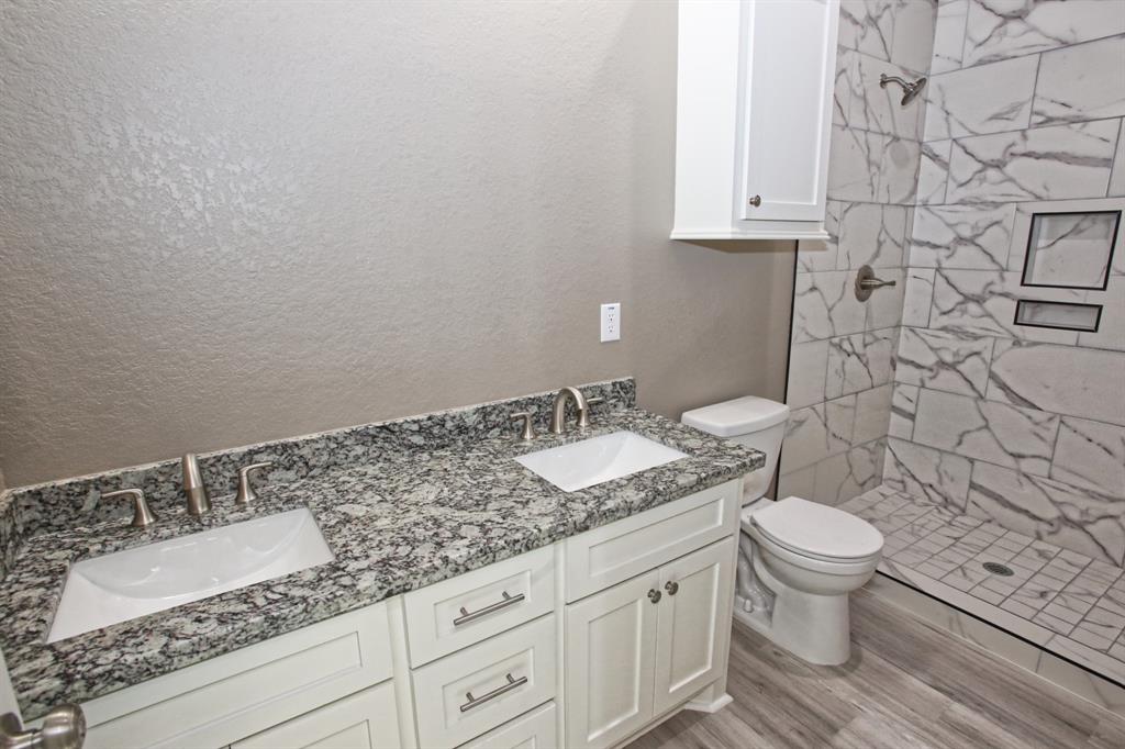 The back hall bath has vanity with two sinks