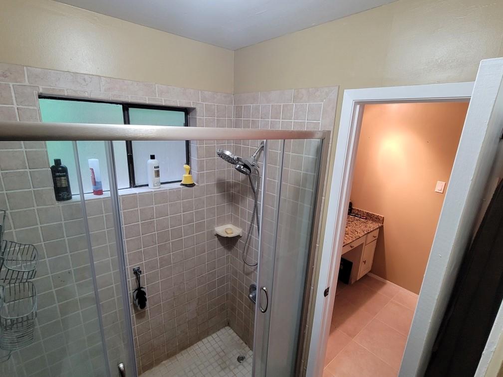 Nice tiled walk in shower with door for privacy from the lavatory and bedroom.