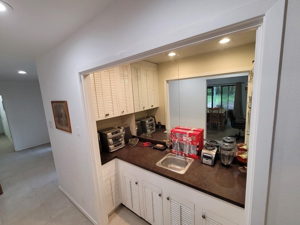 Between the front door and the kitchen is this cute wet bar great for entertaining and parties.