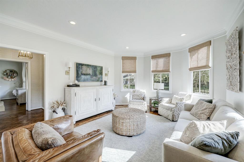 The living room overlooking the front and side yards absolutely exudes comfort and is so bright, with plenty of room for ample furniture pieces.