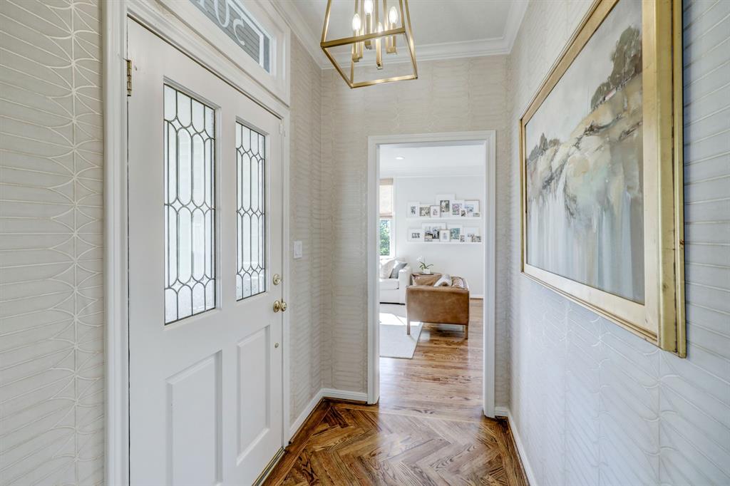 Inside the front door a foyer separates living space and one of the first floor bedrooms.  When these sellers purchased the home they worked with a designer to come up with many special touches, including the elegant wallpapered entry.