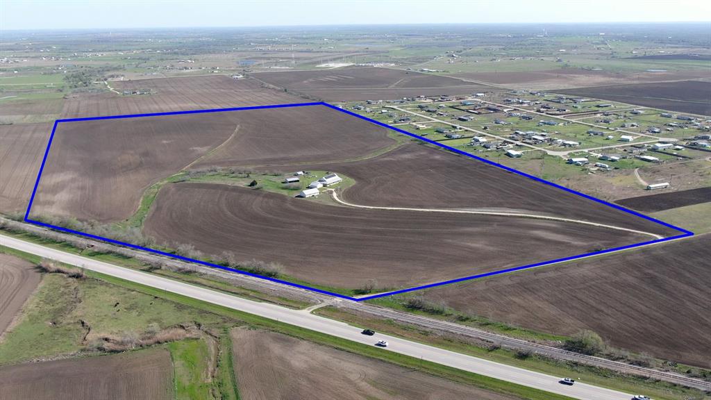 Located 5 miles North of Elgin on HWY 95, this +/- 93 acres of transitional land is situated perfectly in the enormous growth path of Austin, Taylor and Elgin. The property currently has a 2” AQUA water line along Fredrickson Rd servicing the house. Approximately 1500’ away is the closest water main to upgrade into. 
The terrain of the property is gently sloping with no major washout areas and no floodplain. 
The house was designed to be maximum energy efficient with upgraded insulation, solar and full wrap around porch. The house boasts 3 bedrooms 3 baths with a detached HVAC shop on its own septic which would make an ideal mancave or commercial office. On the property is also a detached garage and barn for outdoor storage. 
Fredrickson Ln is a county road but needs some upgrading. The Western boundary of the property is the Union Pacific Railroad running from Elgin to Taylor.  
New Survey will be needed.