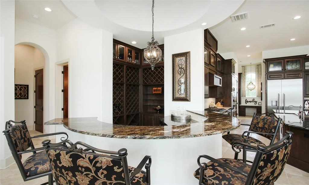 The bar with wine storage, wine refrigerator and ice maker is work of art and centerpiece of the downstairs area.