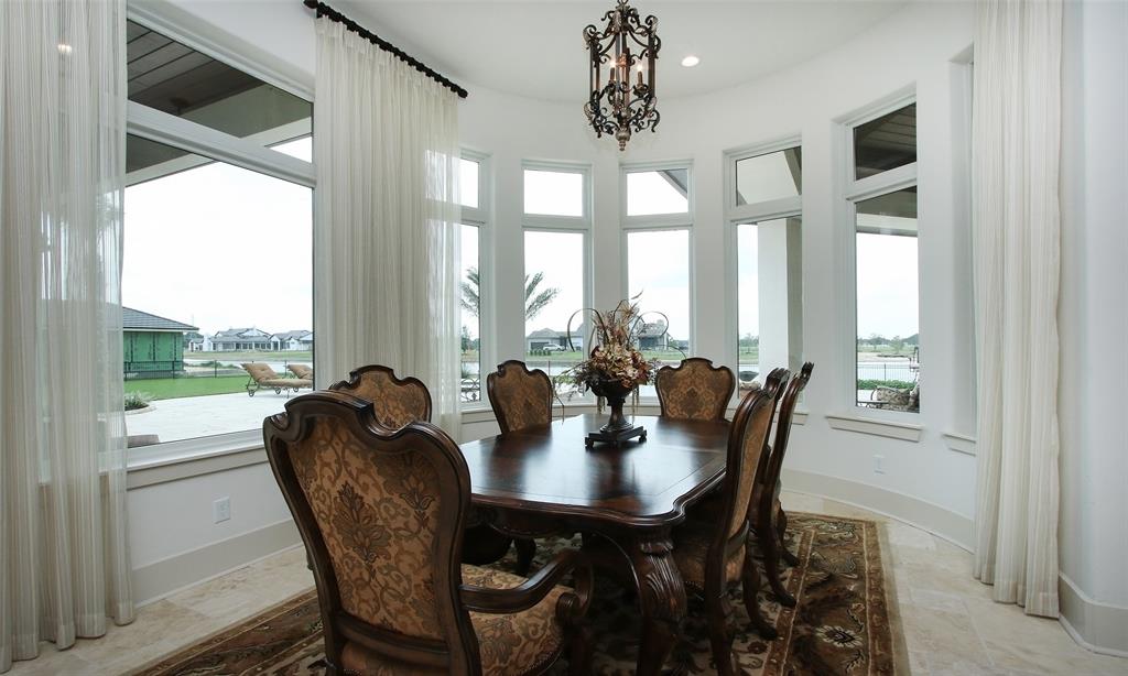 Dining area flanked with windows can be formal or casual depending on your style.  How would you like to have all of your meals in this incredible spot?