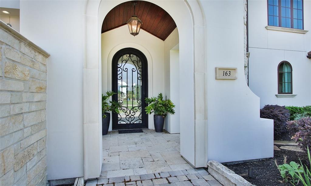 Enter this home through a beautiful covered entry leading to a quaint private courtyard.  No designer touches spared with incredible iron front door to the wood planked ceiling.