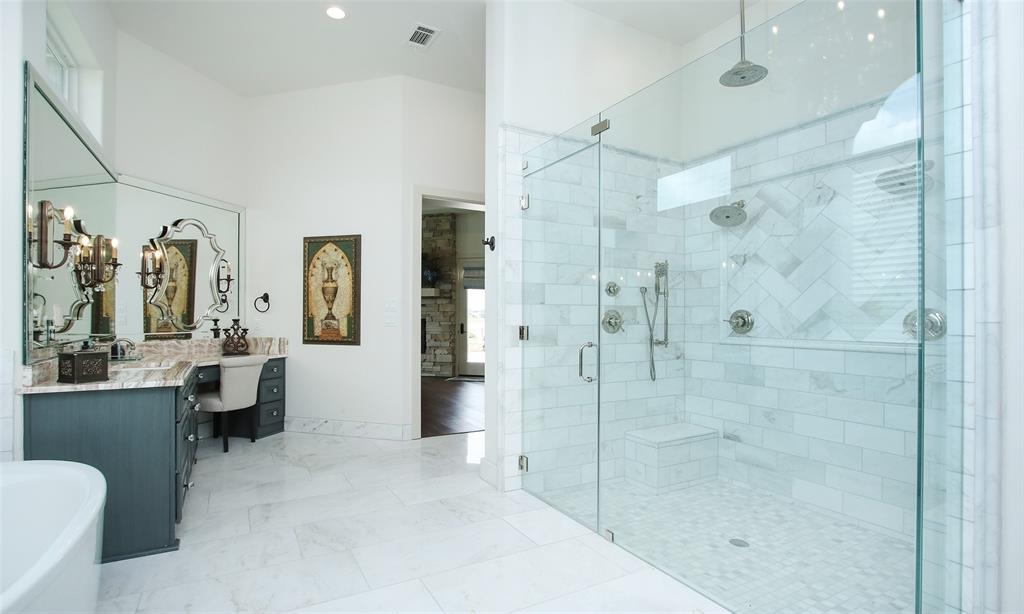 Soaker tub and enormous shower with multiple shower heads and rain shower makes you never want to leave this retreat.