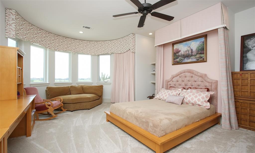This room is fit for a princess!  The custom window coverings and custom bed wall really sets the tone.  So much room in this bedroom for whatever you desire with incredible views as well to the lake and pool area.