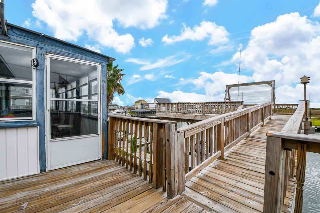 Blue waters and clear blue skies embrace this nautical residence. This ramp gives easy access to the home, left.