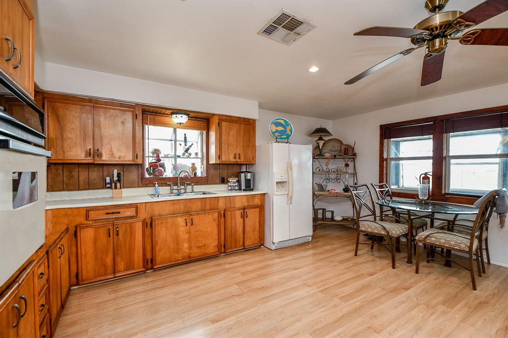 Caramel colored cabinetry fills every inch of wall and floor space in this gorgeous, open kitchen. Even with windows everywhere, one over the kitchen sink is always welcomed!