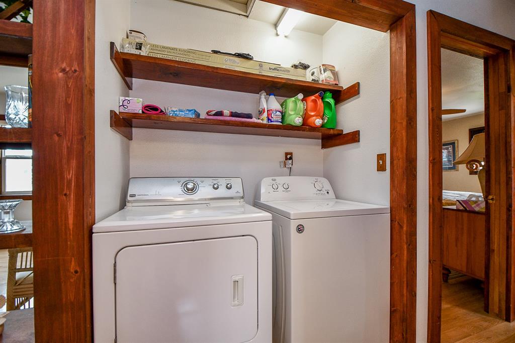 Perfectly placed and tucked away is this compact utililty space, that easily accommodates dual appliances, with handy storage, above.