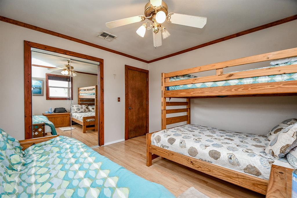 Mirrored, sliding glass doors on a roomy closet add visual space to this bedroom.