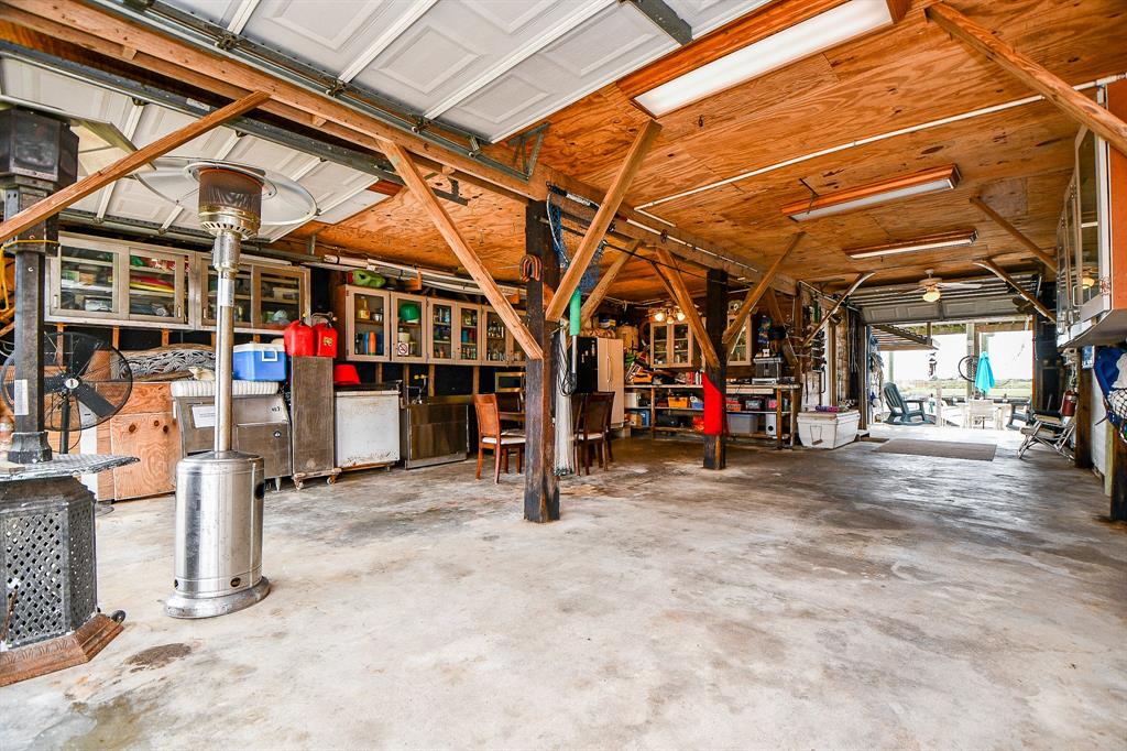 The many built-in storage cabinets and workspace in the garage is a wonderful bonus; with direct access to your outdoor patio, ahead.