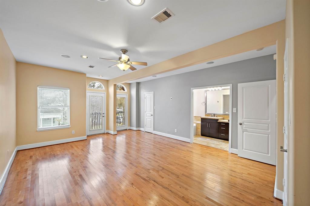 Large primary suite with more vaulted ceilings, 2 Juliet balconies and 2 closets.