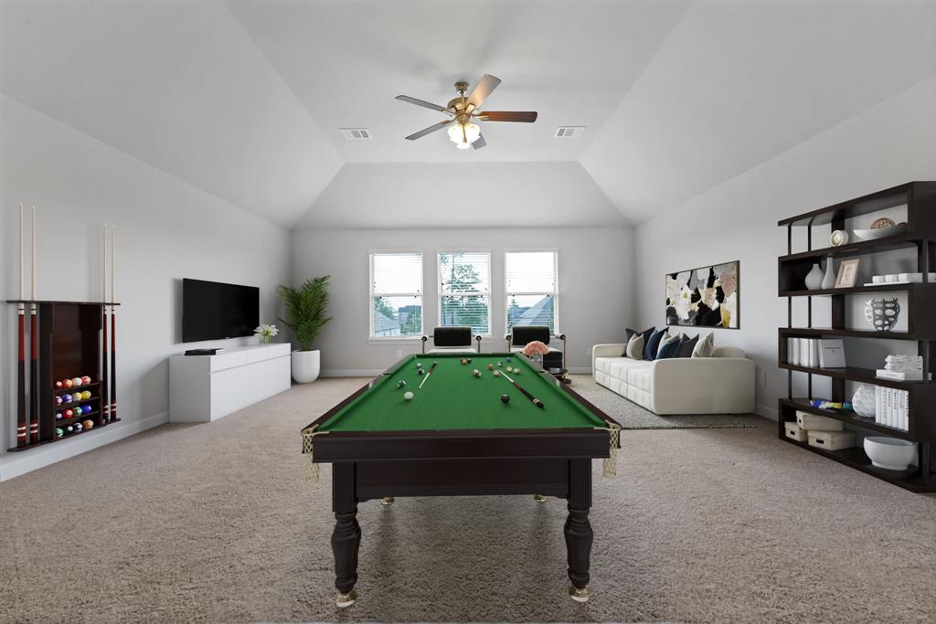Come upstairs and enjoy a day of leisure in this fabulous game room! This is the perfect hangout spot or adult game room, this space features plush carpet, high vaulted ceiling, recessed lighting, custom paint and large windows with privacy blinds.