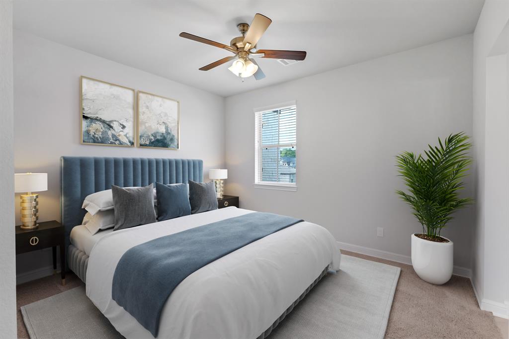 Secondary bedroom features plush carpet, custom paint, dark stained ceiling fan with lighting, large window with privacy blinds and access to the Jack and Jill bath.
