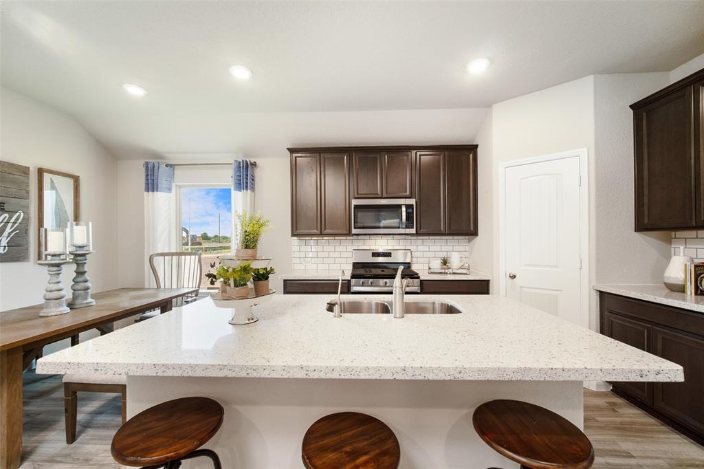 **Home is Under Construction. The photo shown here is of a completed home that has the same floor plan and similar elevation. Options and color selections may vary.**