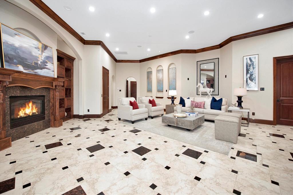 The spacious living room is open to the kitchen and features a beauiful gas fireplace and tons of built in storage. The elevator is located in this room.