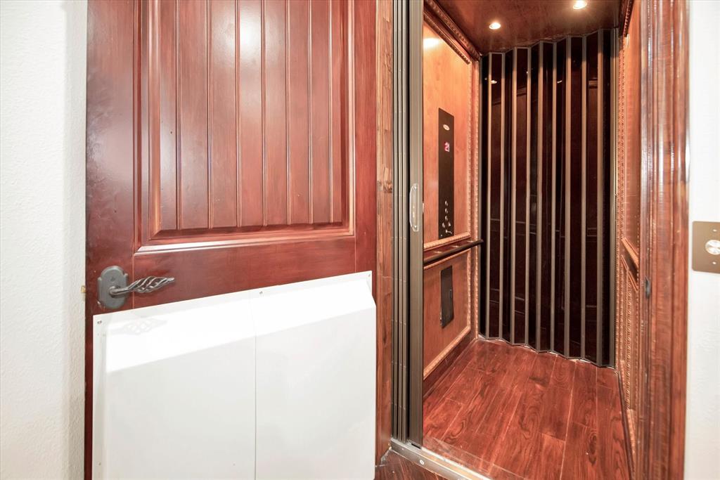 The elevator is located in the living area downstairs and takes you upstairs by the primary bedroom.