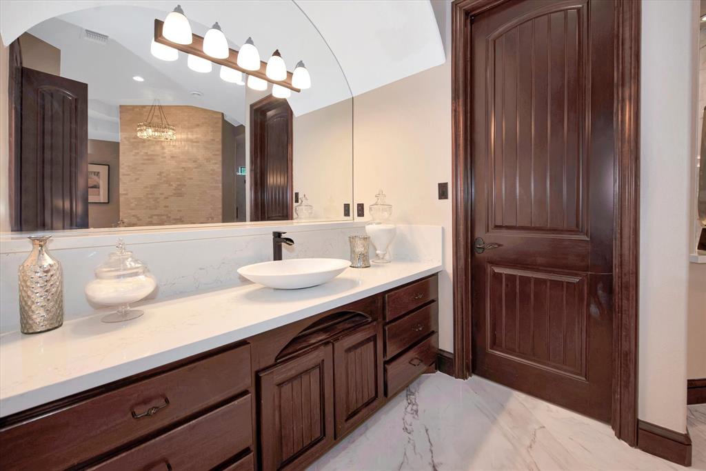 The primary bathroom features a large soaking tub, walkthrough shower, separate double vanities and a fireplace.