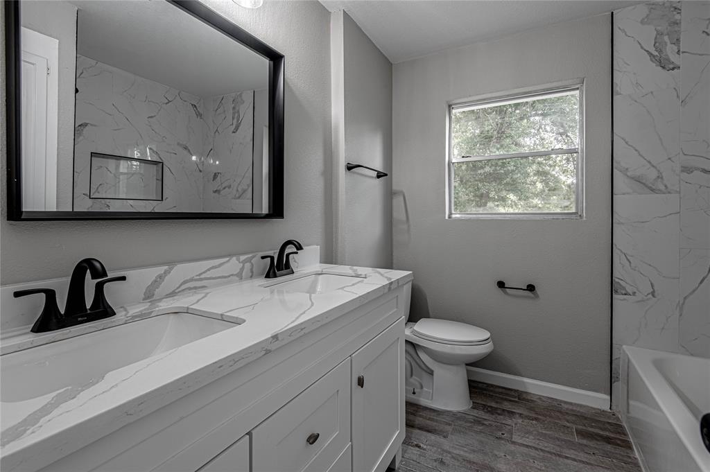 Guest bath with double sinks and extra storage.
