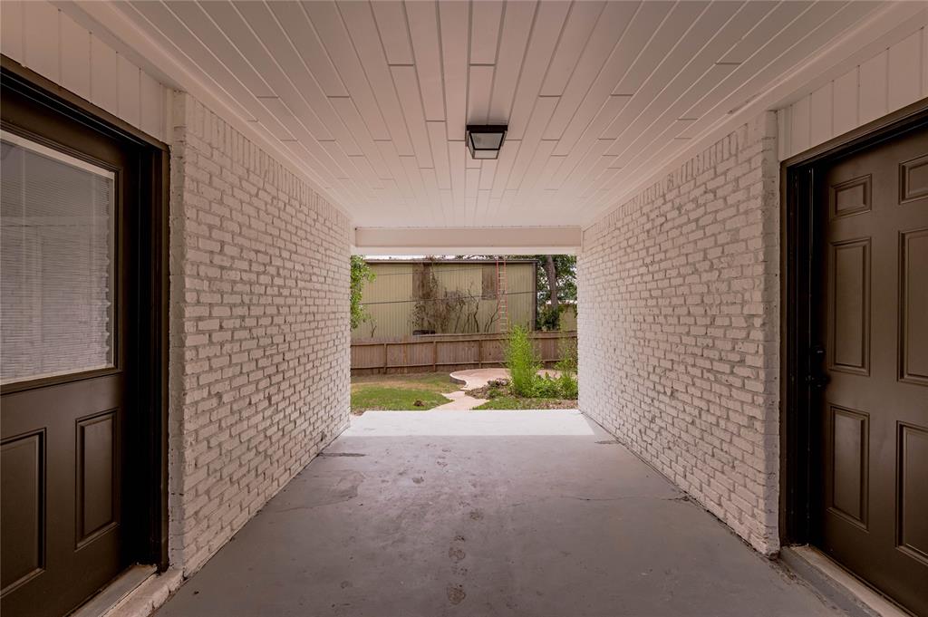 A covered breezeway connects the 2-car garage to the house/