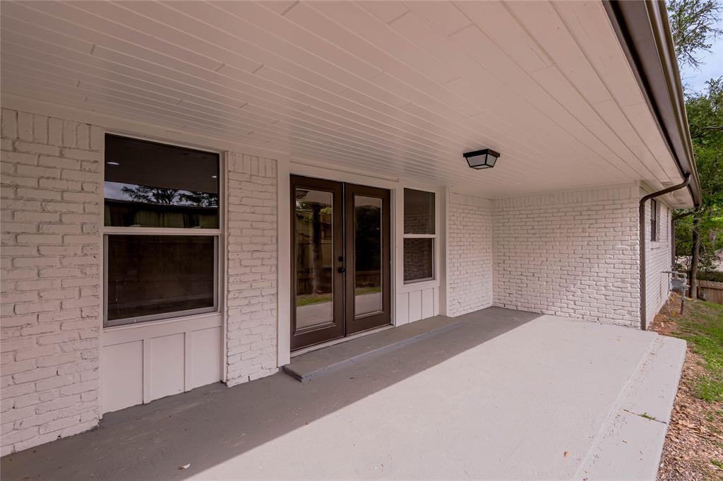 The covered back patio offers a great space for entertaining or relaxing.