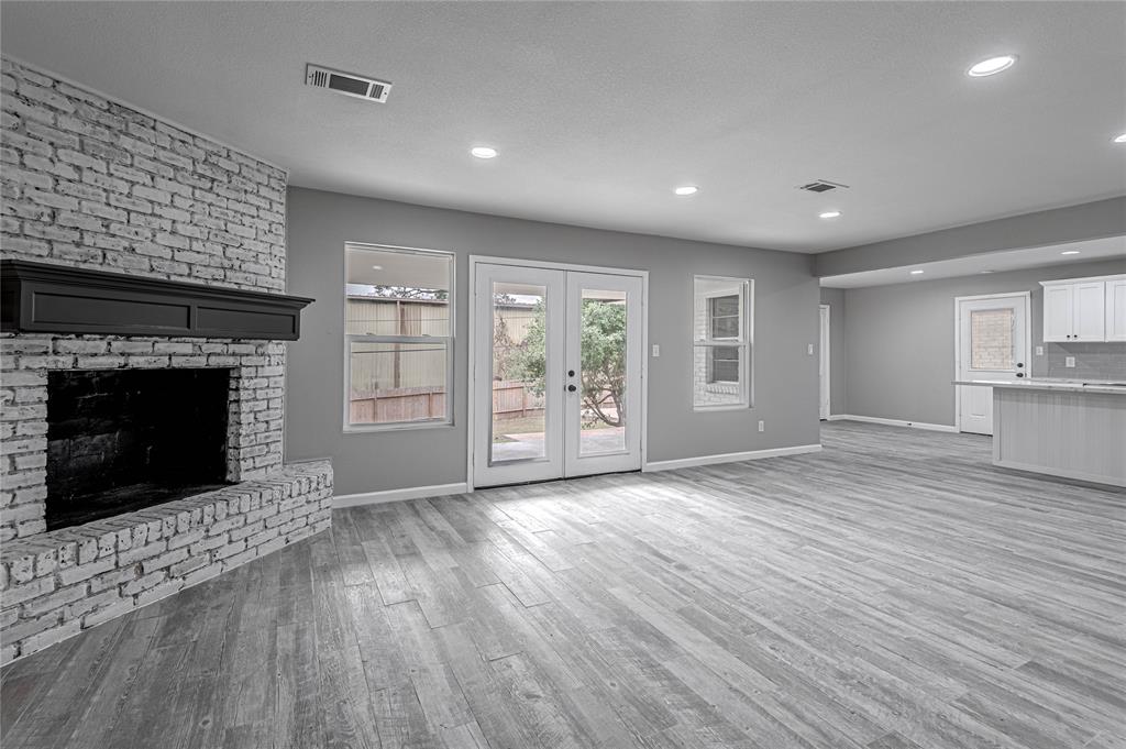 The corner fireplace anchors this living space that is beautifully updated.