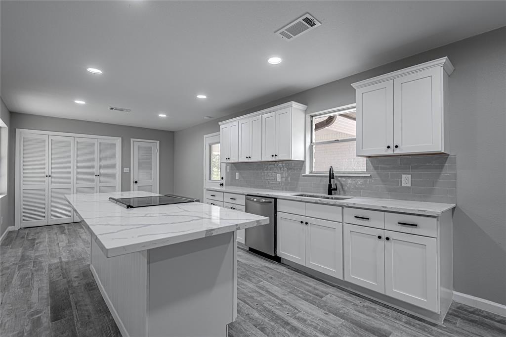 Beautiful new countertops and backsplash make this  kitchen a beautiful place for meal prep or late-night snacking.