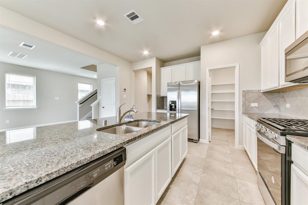 **Home is Under Construction. The photo shown here is of a completed home that has the same floor plan and similar elevation. Options and color selections may vary.**