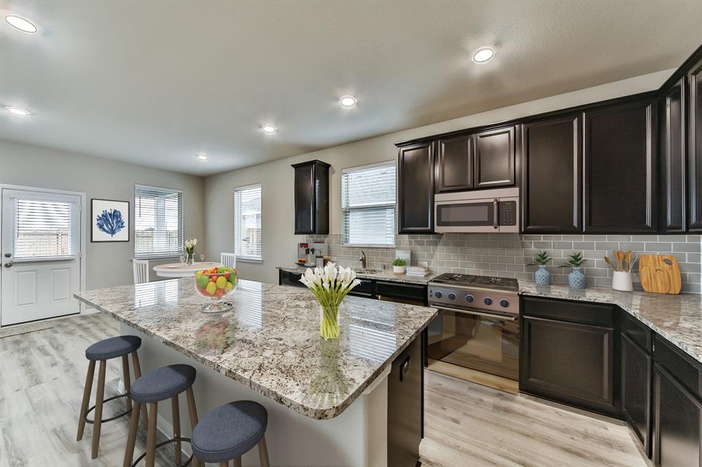 **Home is Under Construction. The photo shown here is of a completed home that has the same floor plan and similar elevation. Options and color selections may vary.**