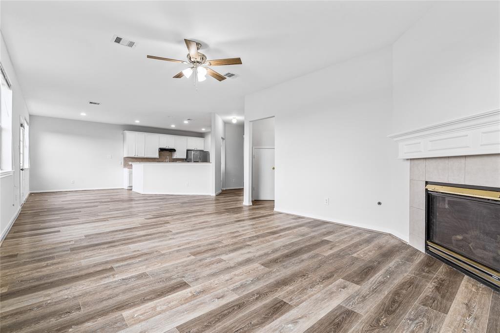 Spacious Living room includes natural lights and fire place.