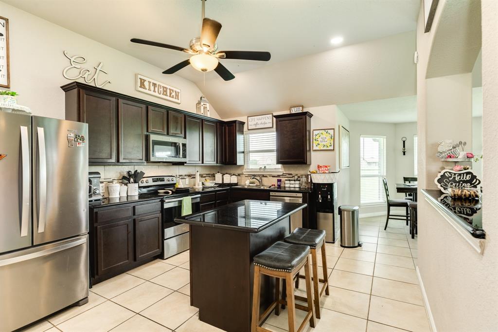 Kitchen has beautiful granite counters, gas cooktop and build in buffet close to dining room and functional island for food prep. Window over the sink. Walk up bar between kitchen and living.