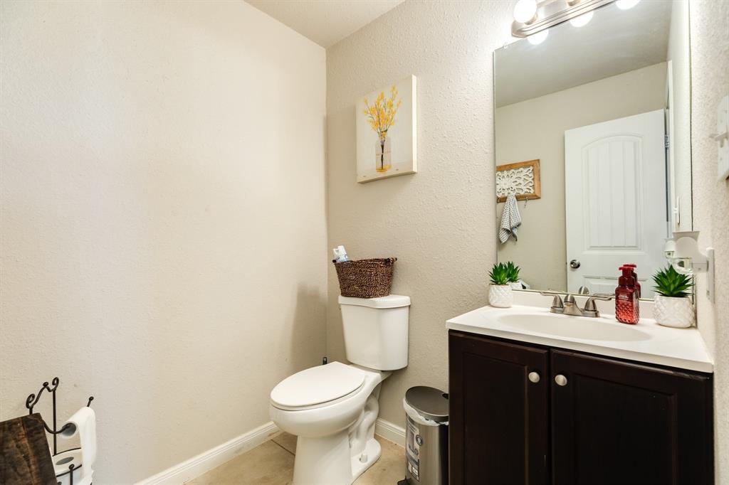 Half bath for guests is close to main living area and kitchen.