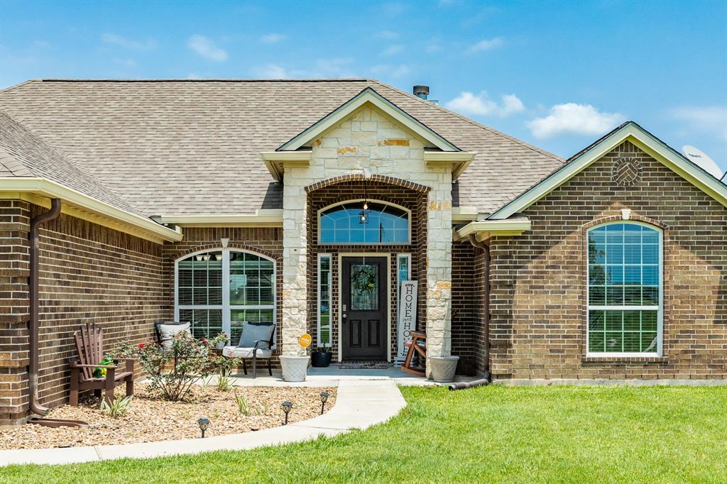 Stone entrance and covered front porch.