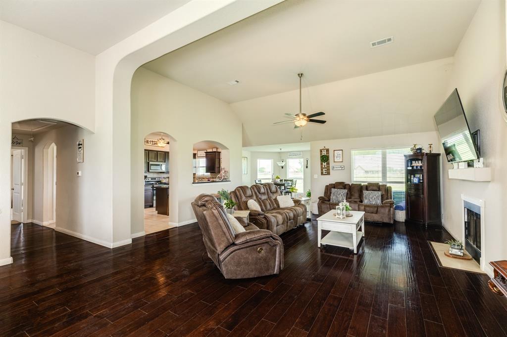 High arched ceiling and friendly fireplace in living