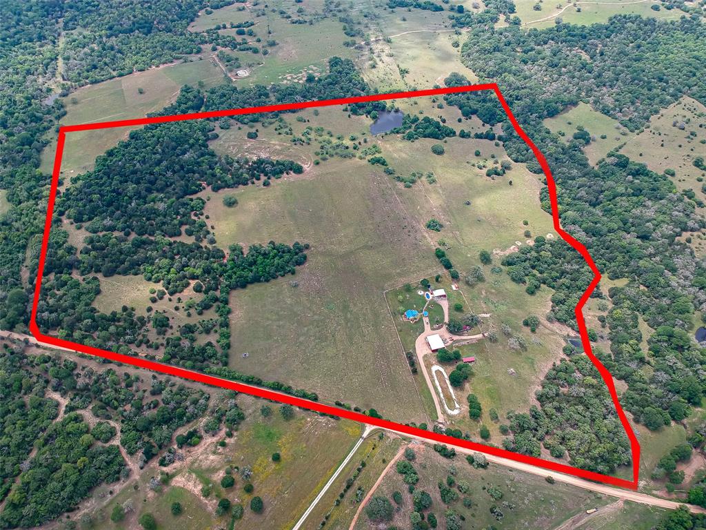 This 102.57 acres is the best of both worlds. Ample acreage for sufficient cattle operation & enough beautiful wooded areas for the hunting enthusiast. Rare find! This beautifully designed & maintained property makes a perfect homestead with room for visitors/family but also a perfect weekend retreat for those looking for a country escape. The main 2 Bd/1BA home built in 1914 is updated with today's conveniences yet keeping with the country feel. It has CA/CH and a cute free standing propane mock fireplace in the living. Attic access leads to many possiblities for add'l bedrooms, kids retreat or great storage. The 2 BD/1BA guest home is located by the inground pool & firepit area. You may find it hard getting guests to leave. A 2000 sf shop with add'l 600 sf covered parking has a full bath & includes 2 Kubota tractors, zero turn mower & other fun toys. Did I mention everything stays? Yes! Tractors, furnishings, dishes, deer blinds/feeders...EVERYTHING! Just bring clothes & toothbrush!