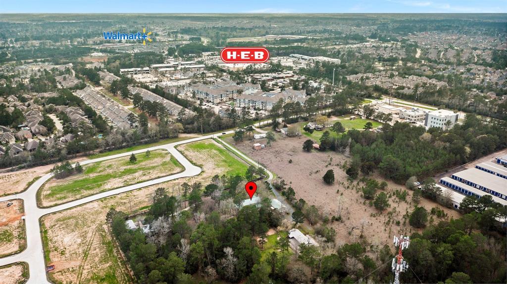This is an unbelievable opportunity to run an on-sight home business, build a dream house, or develop for either commercial or residential use.  This 4.54+ acre tract is .07 miles from the heart of extremely sought after Creekside Park in The Woodlands and adjacent to a new residential development being built.  Walking distance to shopping, schools, parks and more. The last use of the property was a very successful dog kenneling business and it has a dog separate dog kennel on it complete with stalls, building and concrete flooring. Fully fenced, small pond, etc.